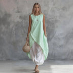 Solid-color sleeveless loose-fit casual dress with patch pockets from Plush Fashion Hub, perfect for relaxed everyday wear.
