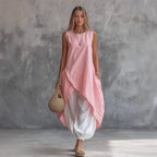 Solid-color sleeveless loose-fit dress with patch pockets, casualwear by Plush Fashion Hub, shown on a model.