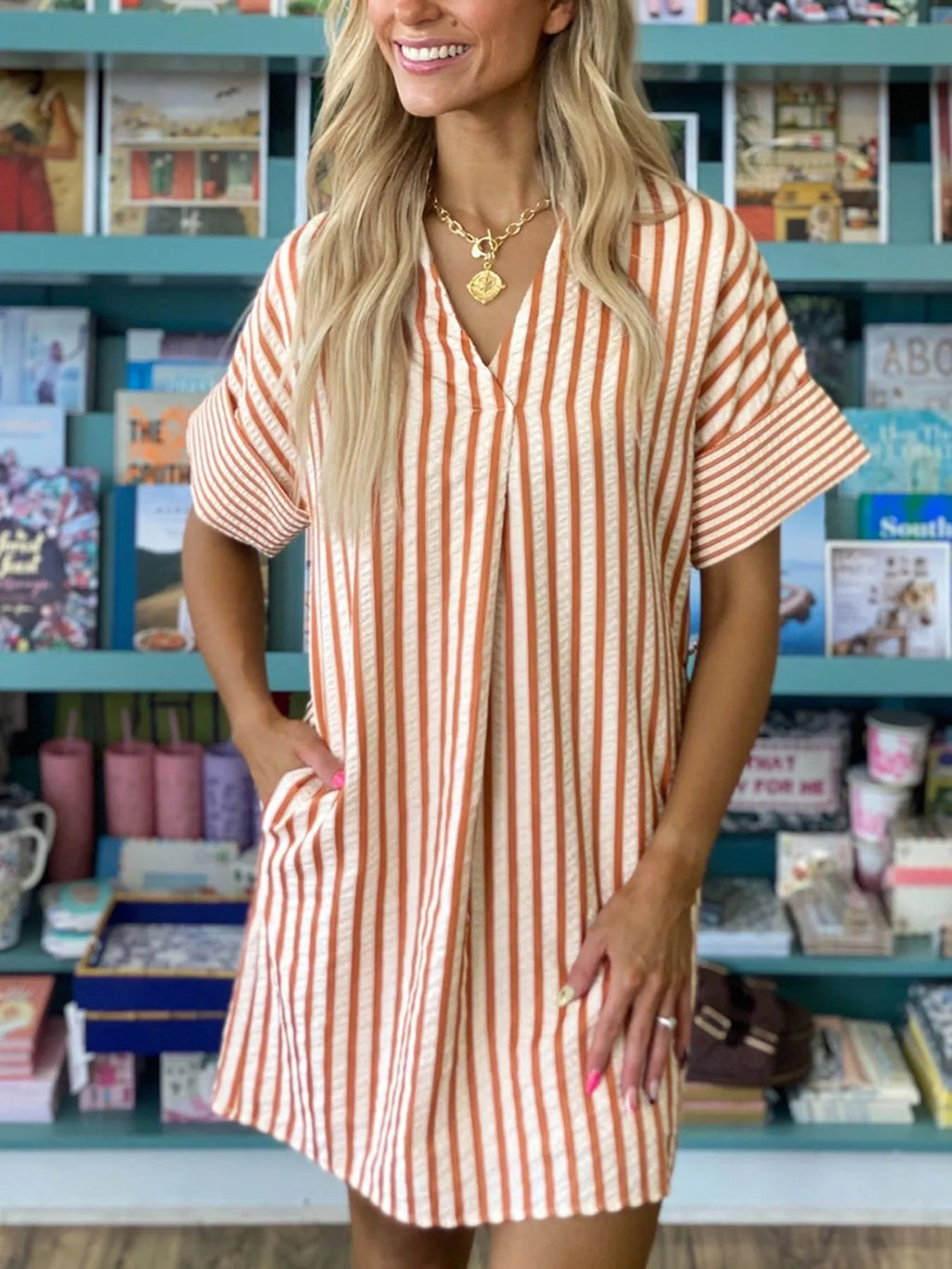 Stripe pinched V-neck mini dress with turn-up cuffs and pockets by Plush Fashion Hub, shown on a model.