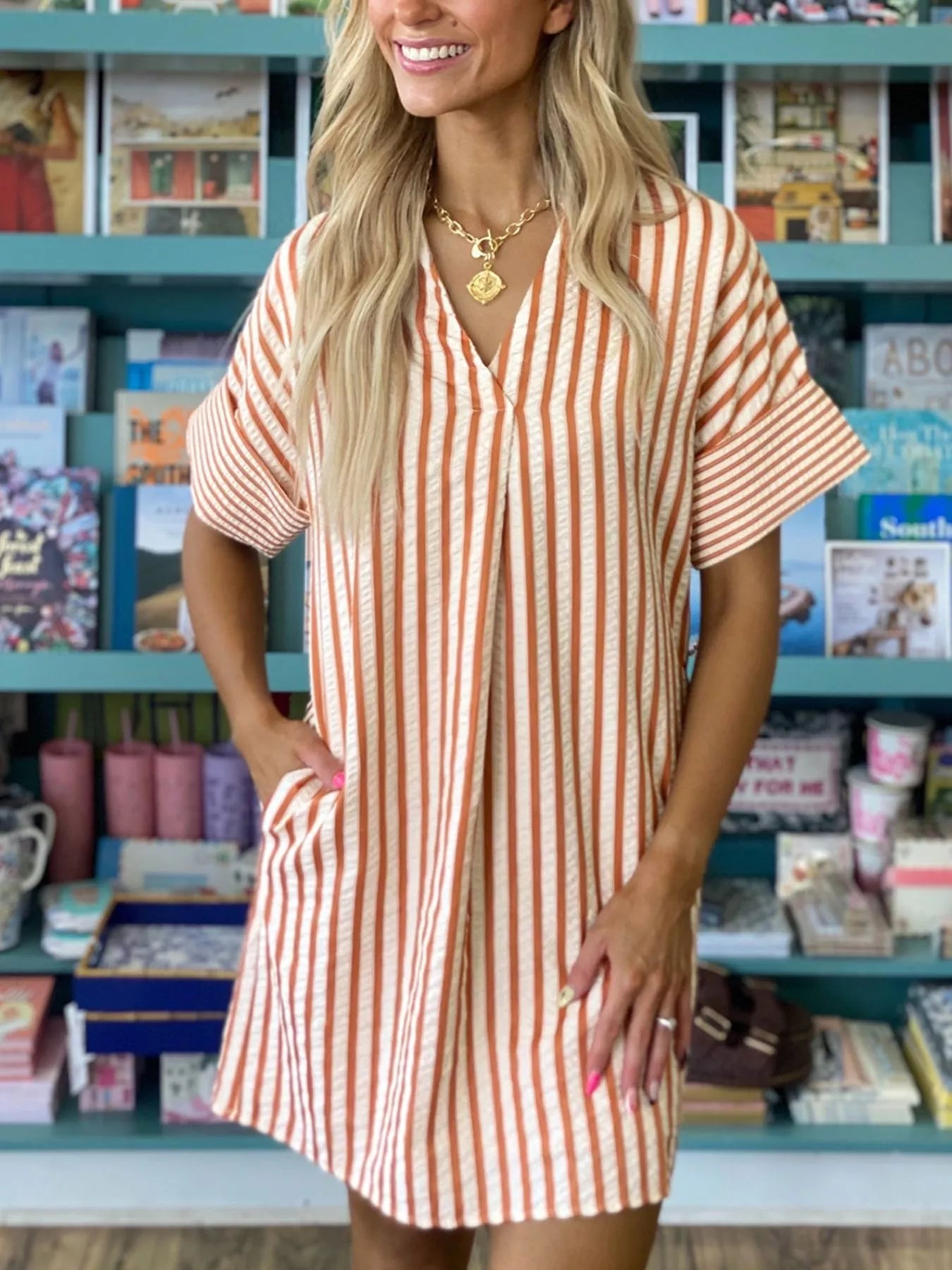 Stripe pinched V-neck mini dress with turn-up cuffs and pockets by Plush Fashion Hub, shown on a model.