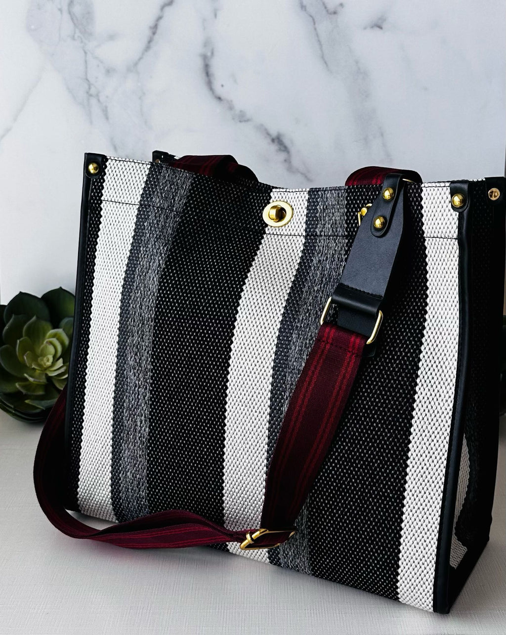 Plush Fashion Hub stripe tote bag with bold striped design, sturdy handles, and spacious interior for everyday use.