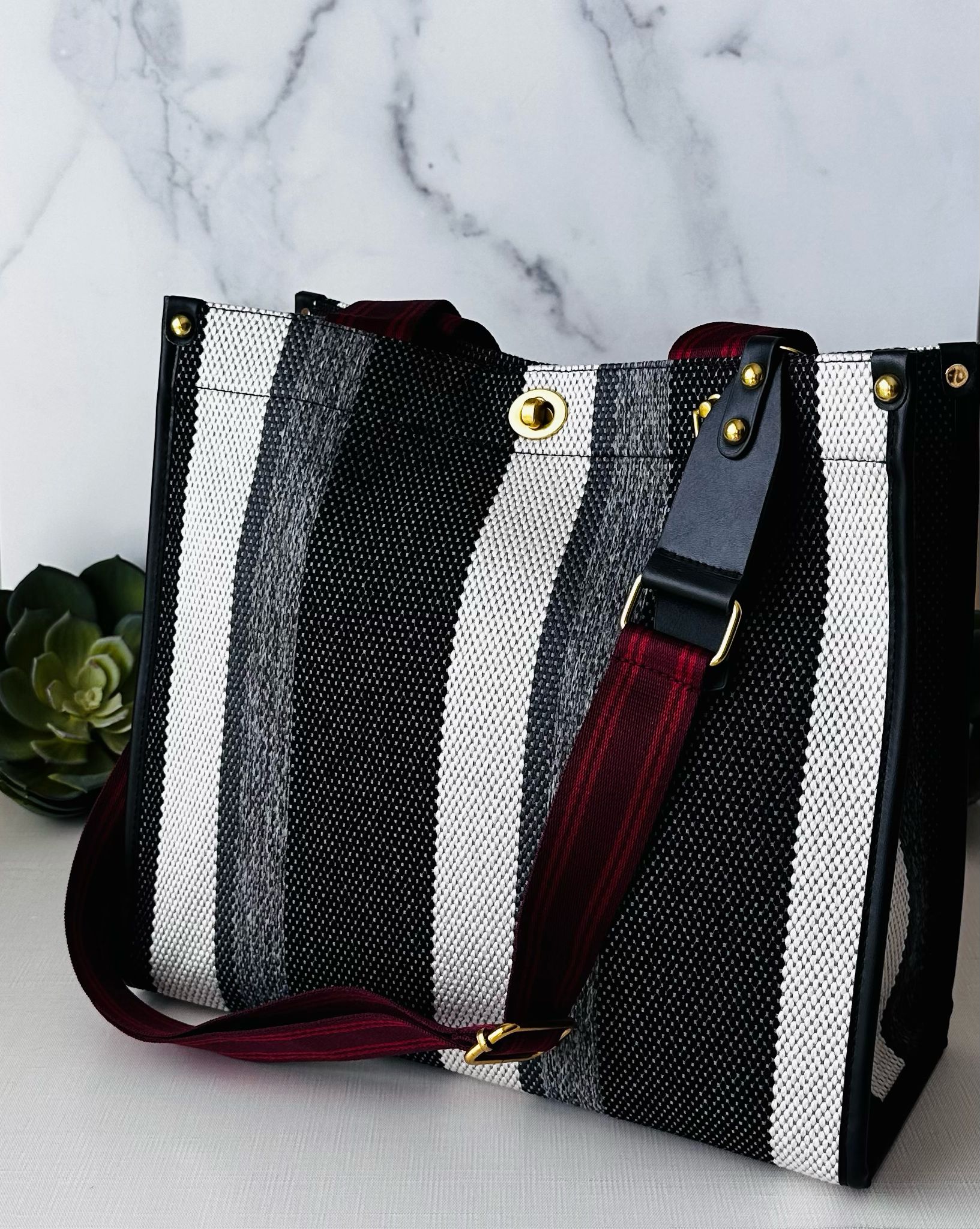 Plush Fashion Hub stripe tote bag with bold striped design, sturdy handles, and spacious interior for everyday use.