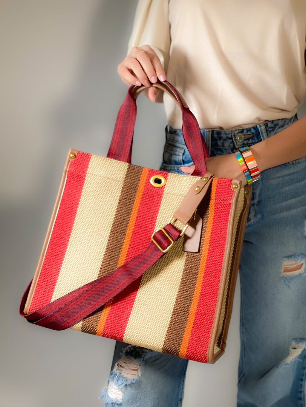 Plush Fashion Hub Stripe Tote bag with black and white striped pattern, featuring sturdy handles and spacious interior.
