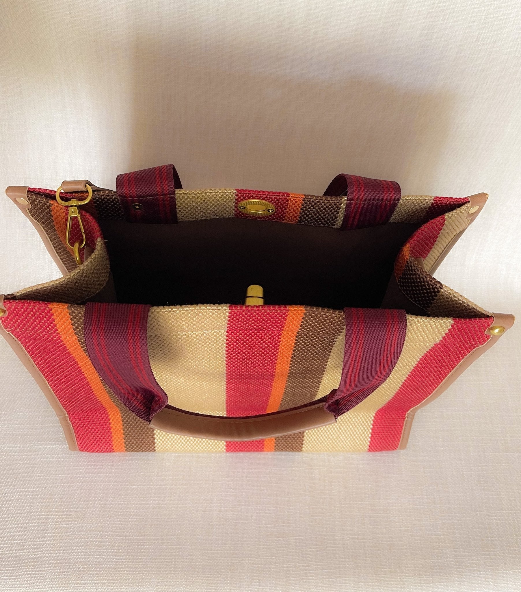 Plush Fashion Hub stripe tote bag with navy and white striped pattern, featuring sturdy handles and spacious interior.