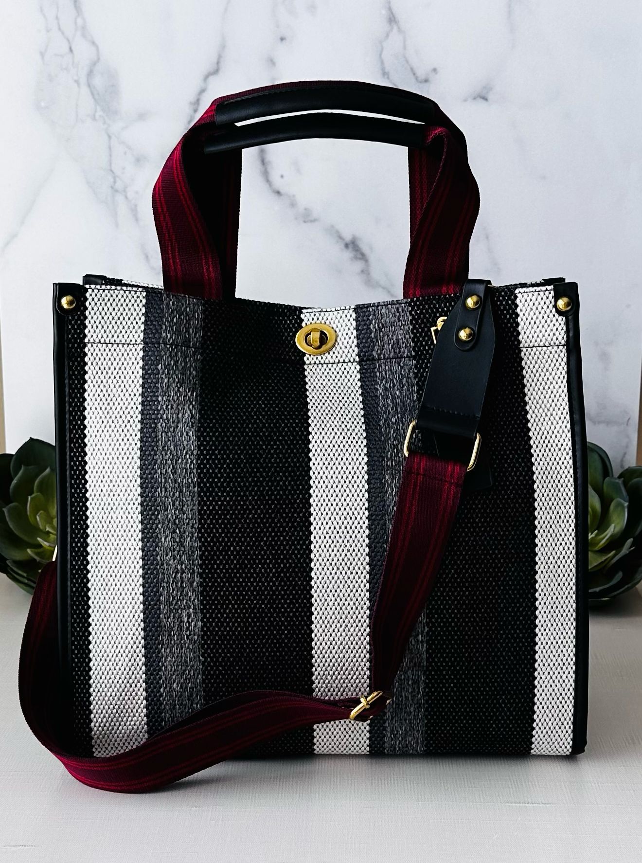 Plush Fashion Hub Stripe Tote featuring a stylish striped fabric design with sturdy handles for everyday use.