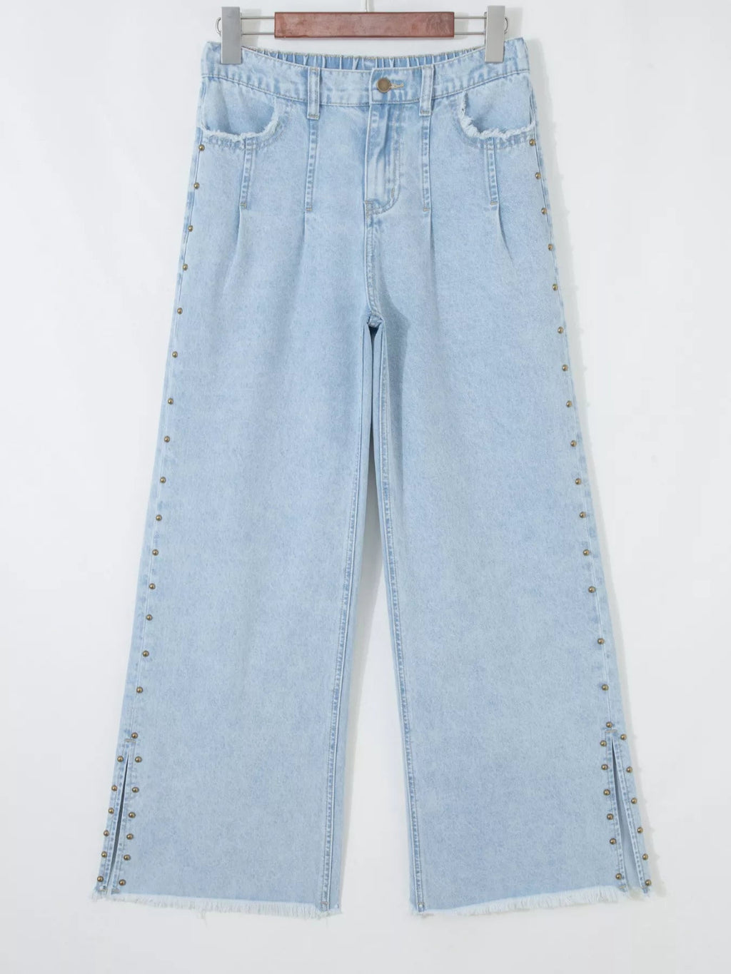 Trendsi studded wide-leg jeans with frayed hem, side slits, and distressed details, styled with a casual, trendy look.