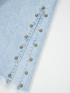 Trendsi studded wide-leg jeans with frayed hem and side slits, showcasing a trendy denim style with embellishments and distressed details.