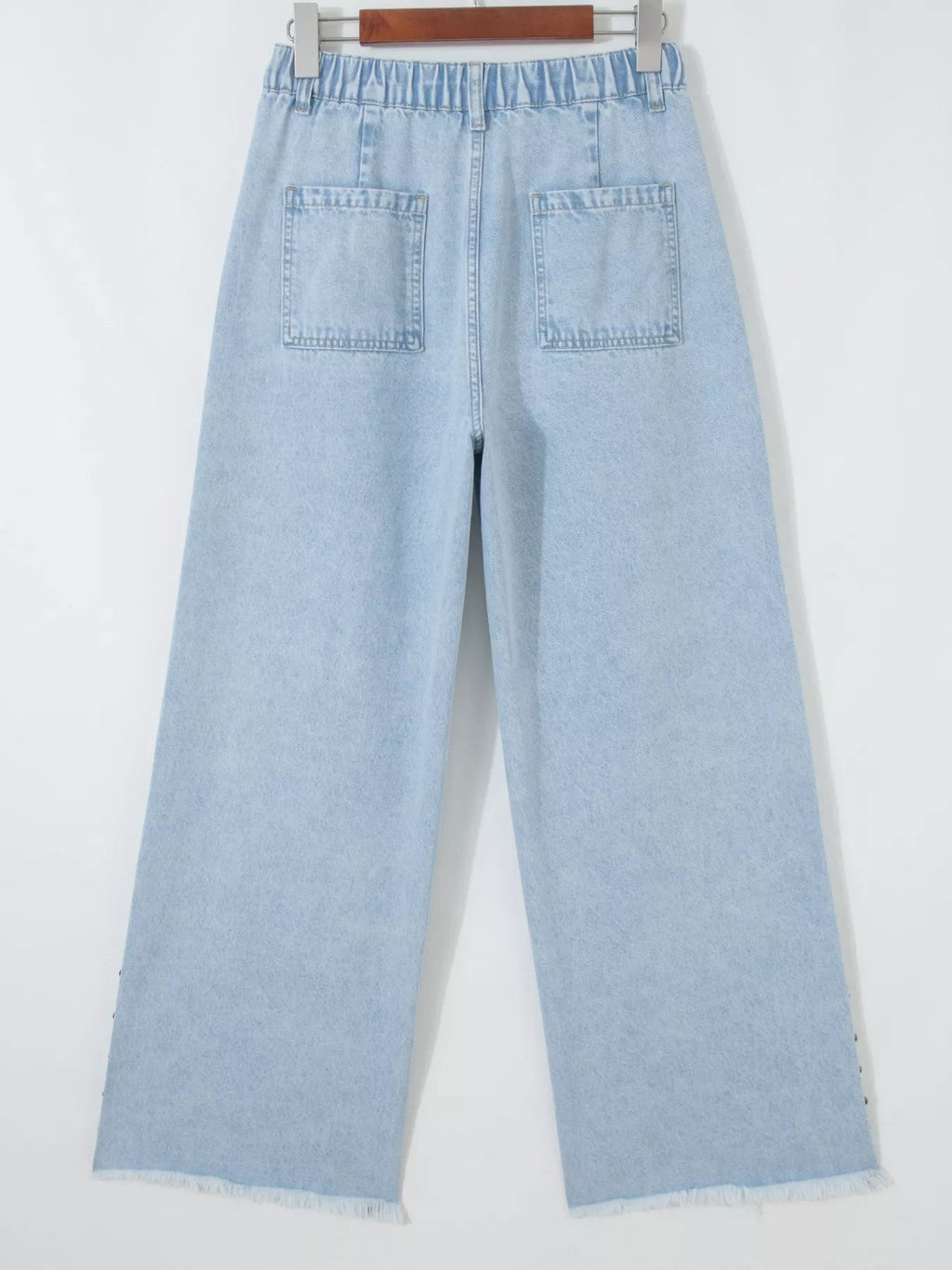 Trendsi studded wide leg jeans with frayed hem and side slits, featuring metal stud accents and relaxed fit.