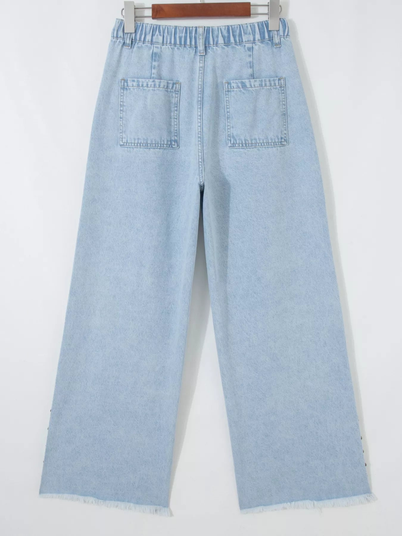Trendsi studded wide leg jeans with frayed hem and side slits, featuring metal stud accents and relaxed fit.
