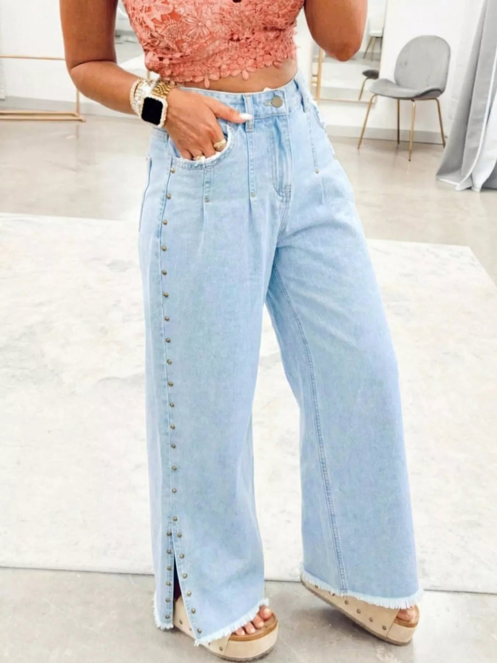Wide-leg jeans with studded details, frayed hem, and side slits from Trendsi, showcasing a trendy, relaxed fit design.