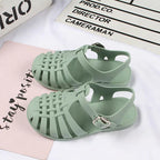 Girls hollow casual flat sandals by Trendy Attic Store01 with open toe design and adjustable straps, suitable for boys and girls.