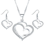 Double heart earrings and necklace wedding set, gold-tone jewelry with matching heart-shaped pendants and earrings.