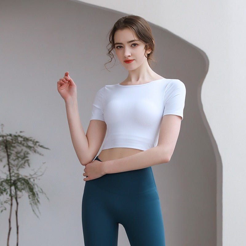 Plush Fashion Hub tight-fit yoga top with chest pad, breathable fabric, and stylish back design for activewear workouts.