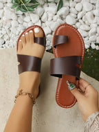Women's vegan PU leather toe loop flat sandals by Trendsi, featuring a comfortable, everyday slip-on shoe design.