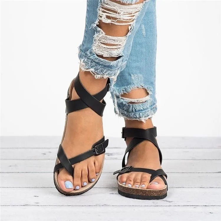 Women's chic PU leather toe-loop flat sandals by Trendsi, minimalist summer footwear with sleek design and comfortable flat sole.
