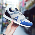 Trendy men's breathable sport casual running shoes in black with white soles, made by Plush Fashion Hub.