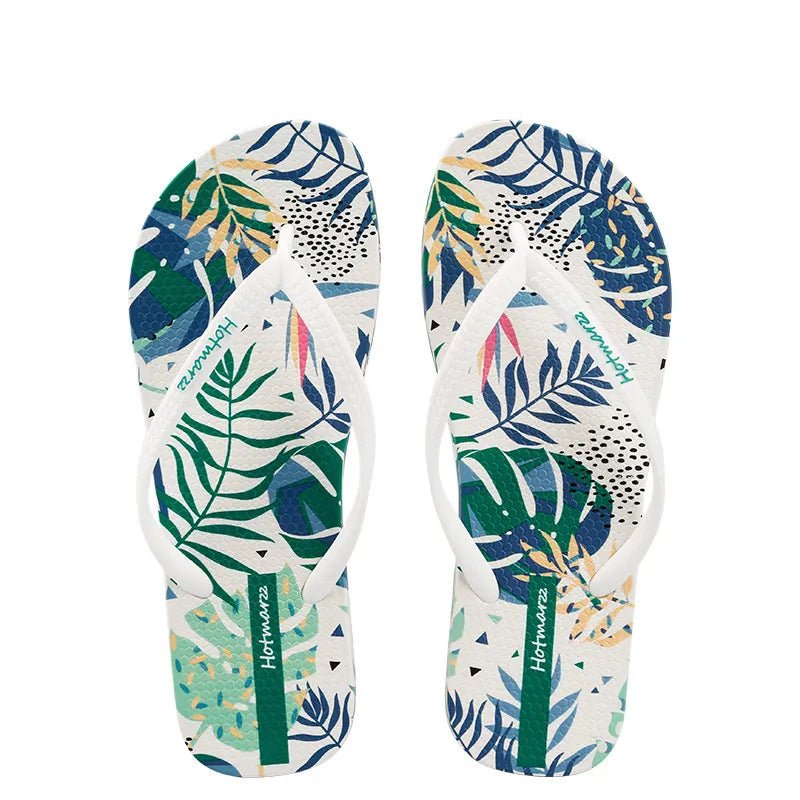 Women's tropical leaf print flat slides by Trendsi, lightweight botanical summer sandals with vibrant leaf pattern.