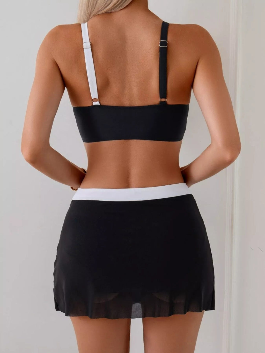 Women's two-tone cami and skort swim set by Trendsi, stylish two-piece swimwear perfect for beach or poolside lounging.