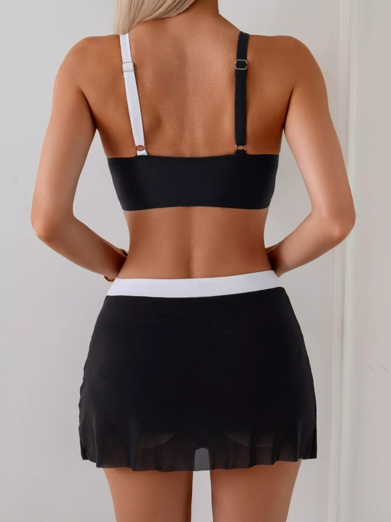 Women's two-tone cami and skort swim set by Trendsi, stylish two-piece swimwear perfect for beach or poolside lounging.