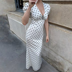 Elegant black maxi dress by Bella Mia with V-neck, lace-up waist, puff sleeves, and polka dots for a stylish, slimming look.