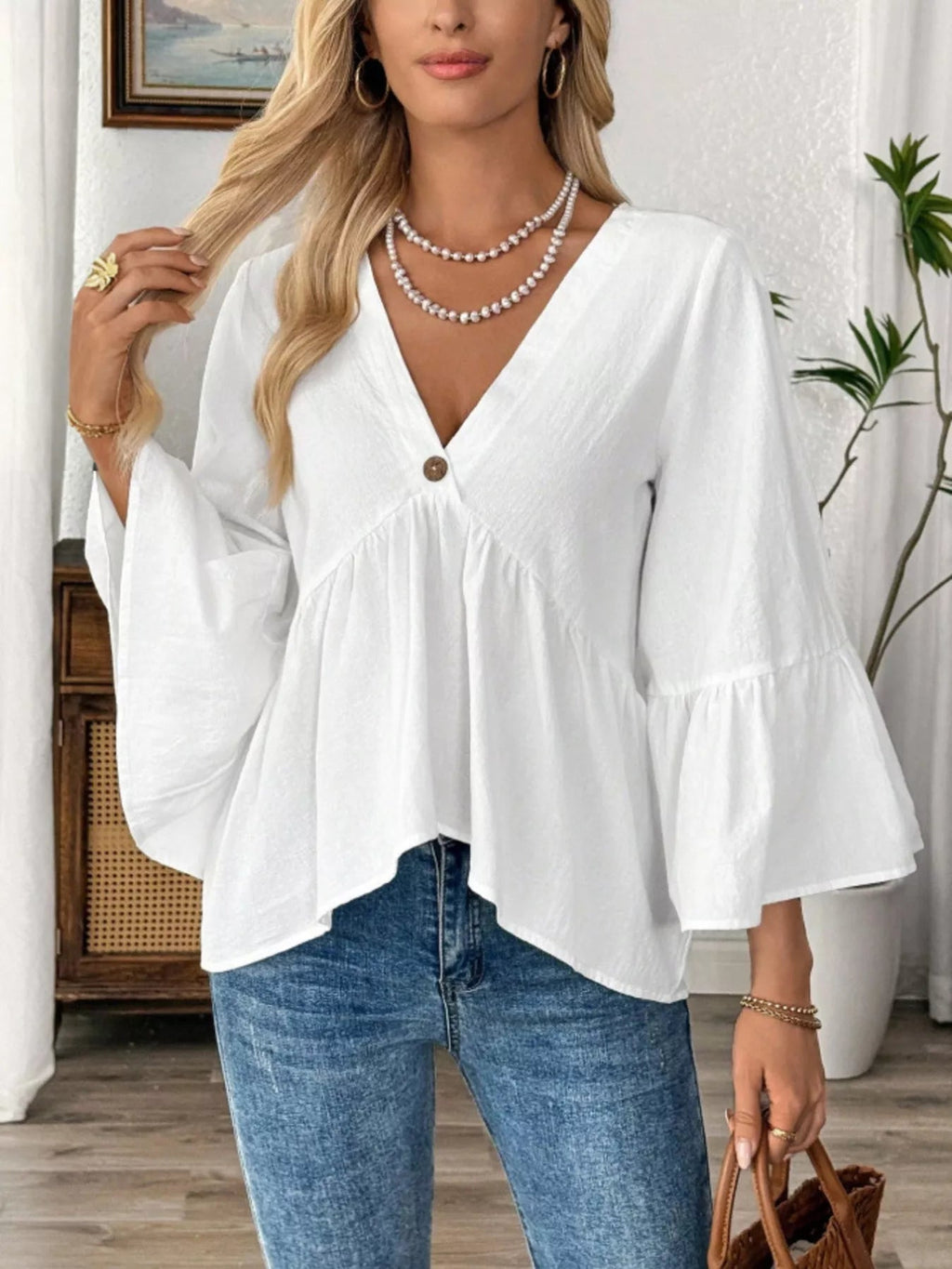 Women's 100% cotton V-neck bell sleeve blouse with a chic, effortless style, featuring flowy bell sleeves and a relaxed fit.