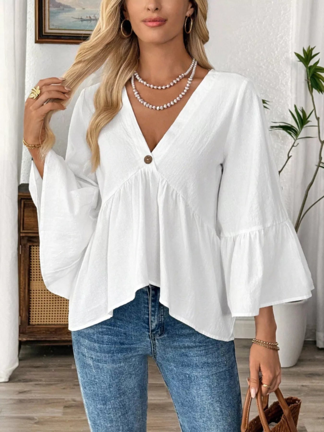 Women's 100% cotton V-neck bell sleeve blouse with a chic, effortless style, featuring flowy bell sleeves and a relaxed fit.
