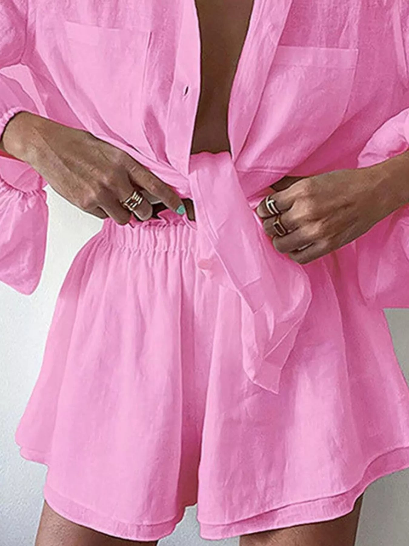 Women's long sleeve button-up shirt and shorts lounge set by Trendsi, comfortable two-piece clothing set for casual wear.