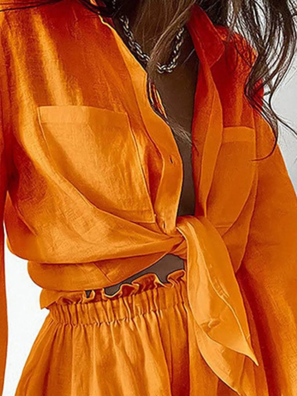 Women's button-up long sleeve shirt and shorts two-piece lounge set by Trendsi, casual and comfortable for relaxed wear.