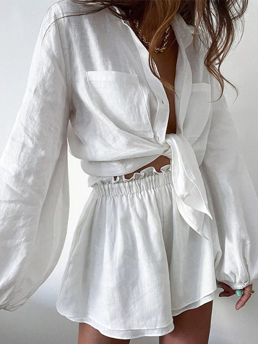 Women's long sleeve button-up shirt and shorts lounge set by Trendsi, soft fabric, casual two-piece clothing ensemble.
