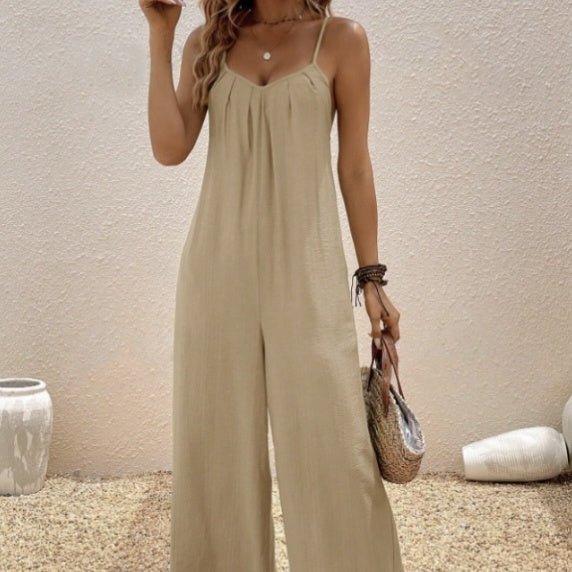 Women’s sleeveless V-neck casual suspender jumpsuit by Plush Fashion Hub, solid color, one-piece with relaxed fit and adjustable straps.
