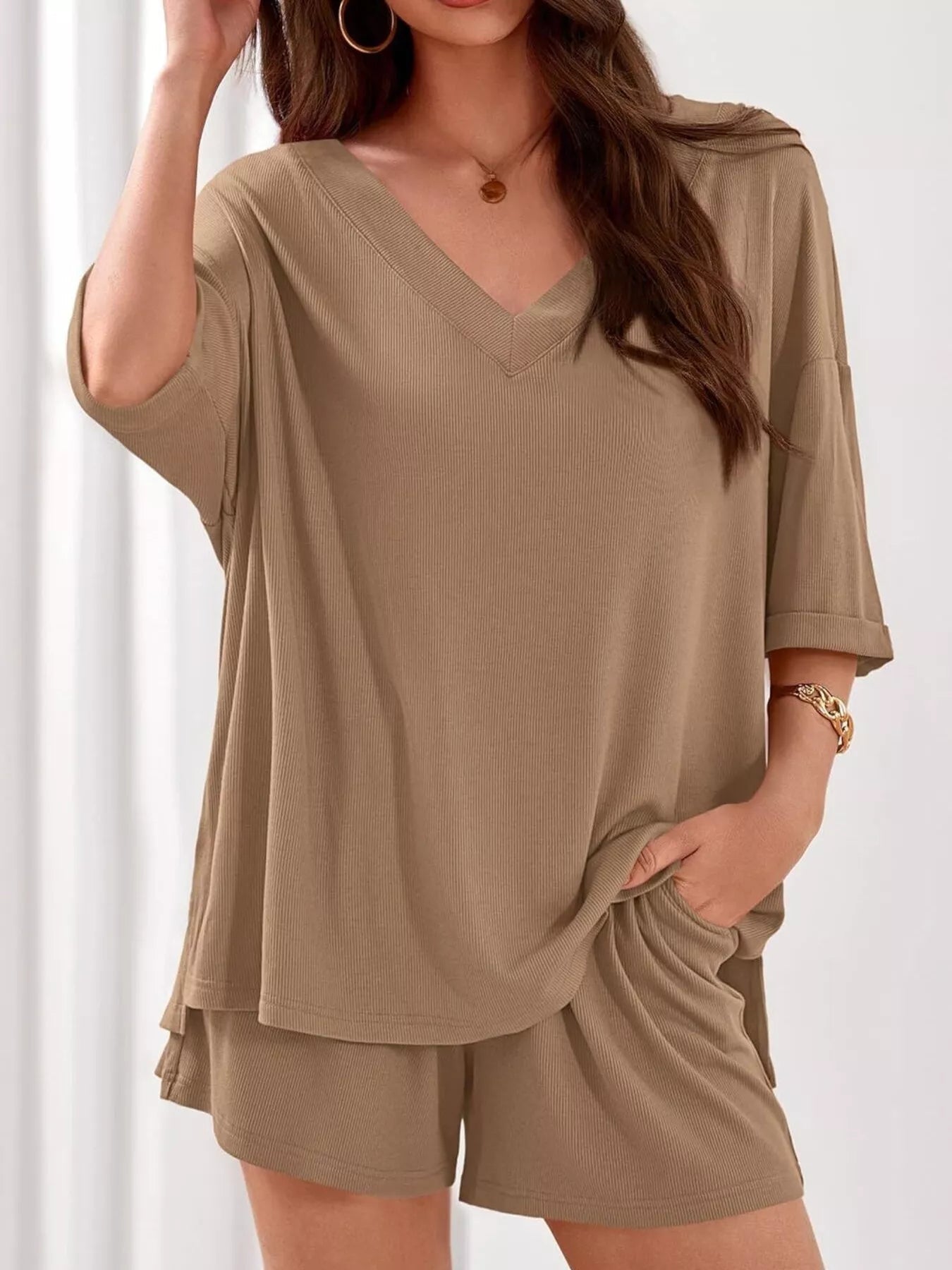 Women's casual V-neck top and shorts set in solid color, trendy two-piece clothing set by Trendsi, perfect for relaxed everyday wear.