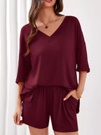 Women's casual V-neck top and shorts set in solid color, trendy two-piece outfit, perfect for relaxed summer wear.