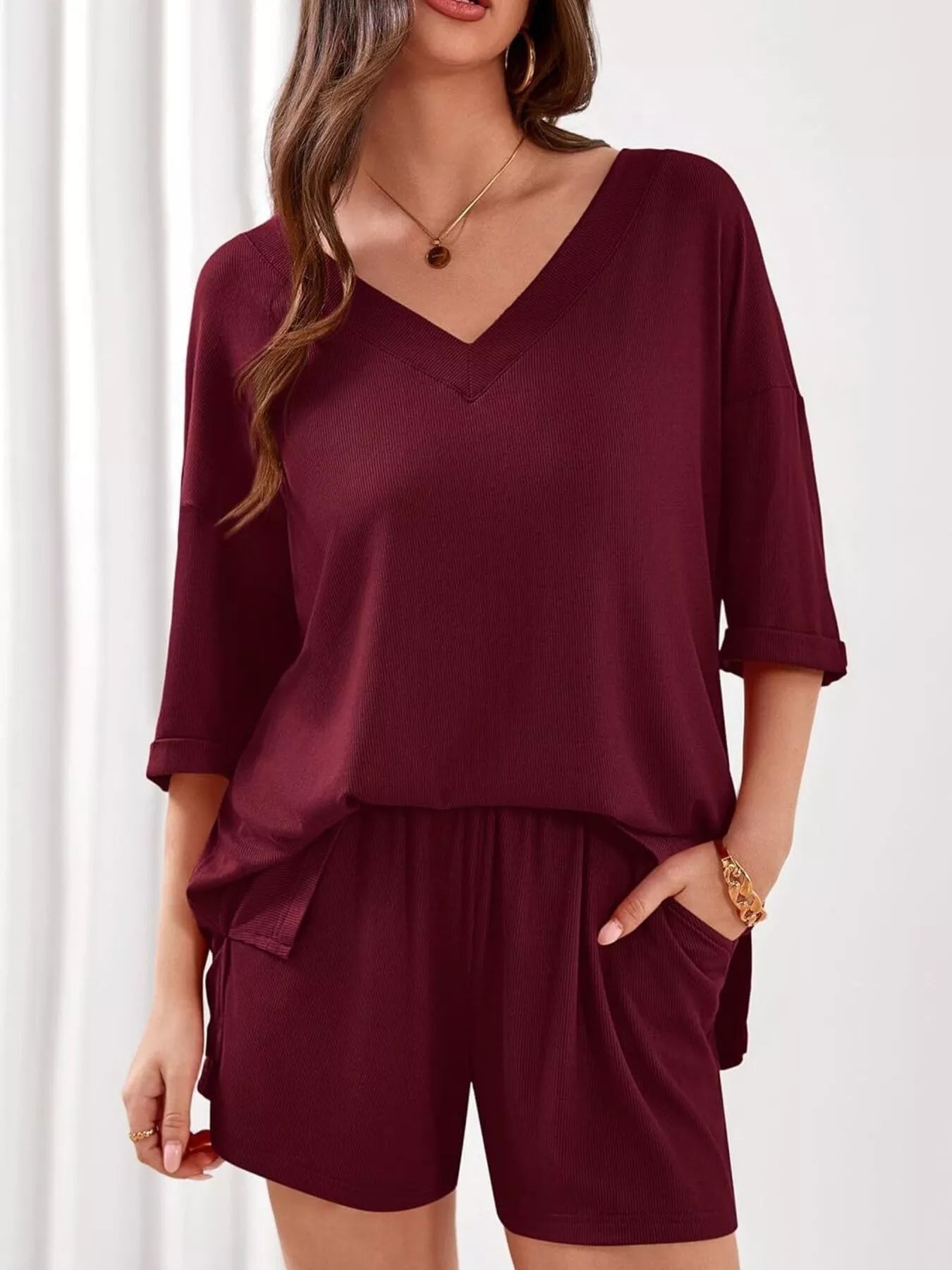 Women's casual V-neck top and shorts set in solid color, trendy two-piece outfit, perfect for relaxed summer wear.