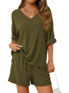 Women's casual V-neck top and shorts set, solid color two-piece outfit by Trendsi, shown on a model.