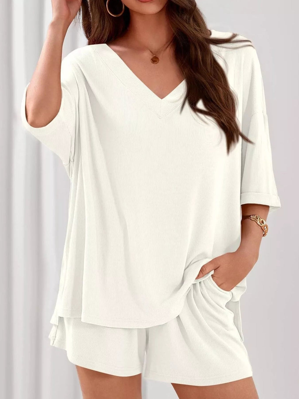 Women's casual V-neck top and shorts set, solid color two-piece outfit by Trendsi, featuring a comfortable and stylish clothing set.