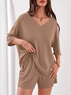 Women's casual V-neck top and shorts set by Trendsi, solid color two-piece outfit, perfect for relaxed and stylish summer wear.