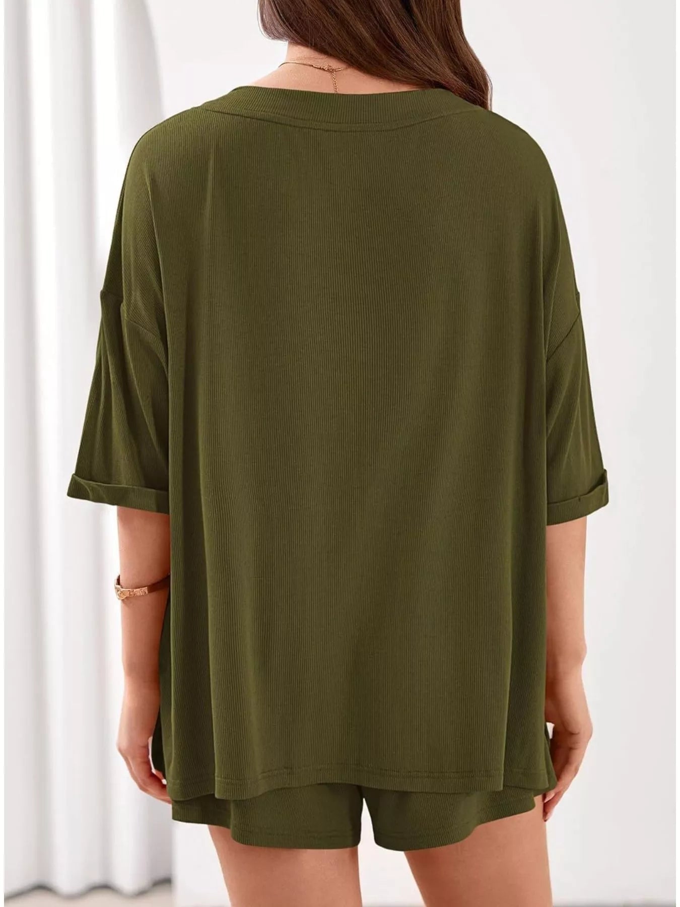 Women's casual V-neck top and shorts set in solid color, trendy two-piece outfit by Trendsi, perfect for relaxed everyday wear.