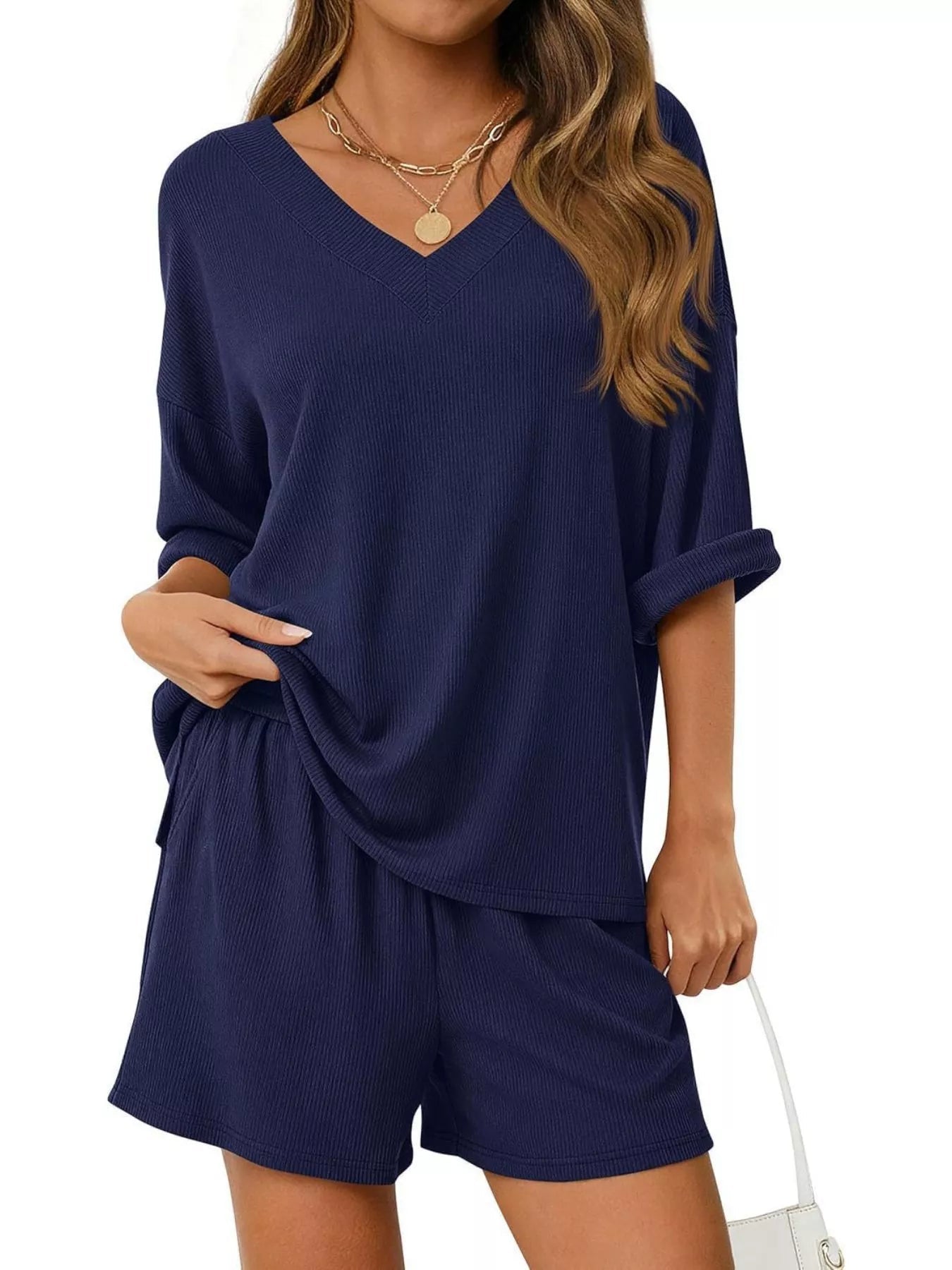 Women's casual V-neck top and shorts set in solid color, trendy two-piece outfit by Trendsi, perfect for relaxed everyday wear.