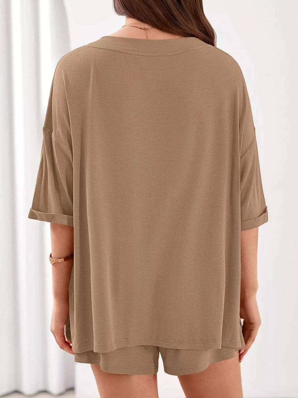Women's casual V-neck top and shorts set in solid color, trendy two-piece clothing set by Trendsi, perfect for relaxed everyday wear.