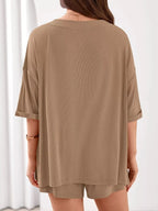Women's casual V-neck top and shorts set in solid color, trendy two-piece clothing set by Trendsi, perfect for relaxed everyday wear.
