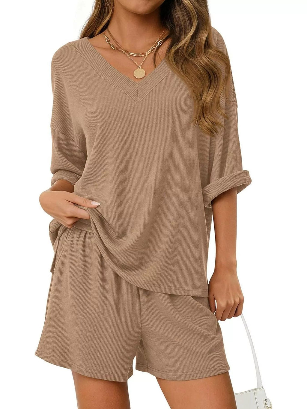 Women's casual V-neck top and shorts set in solid color, trendy two-piece outfits by Trendsi. Perfect for relaxed, stylish wear.