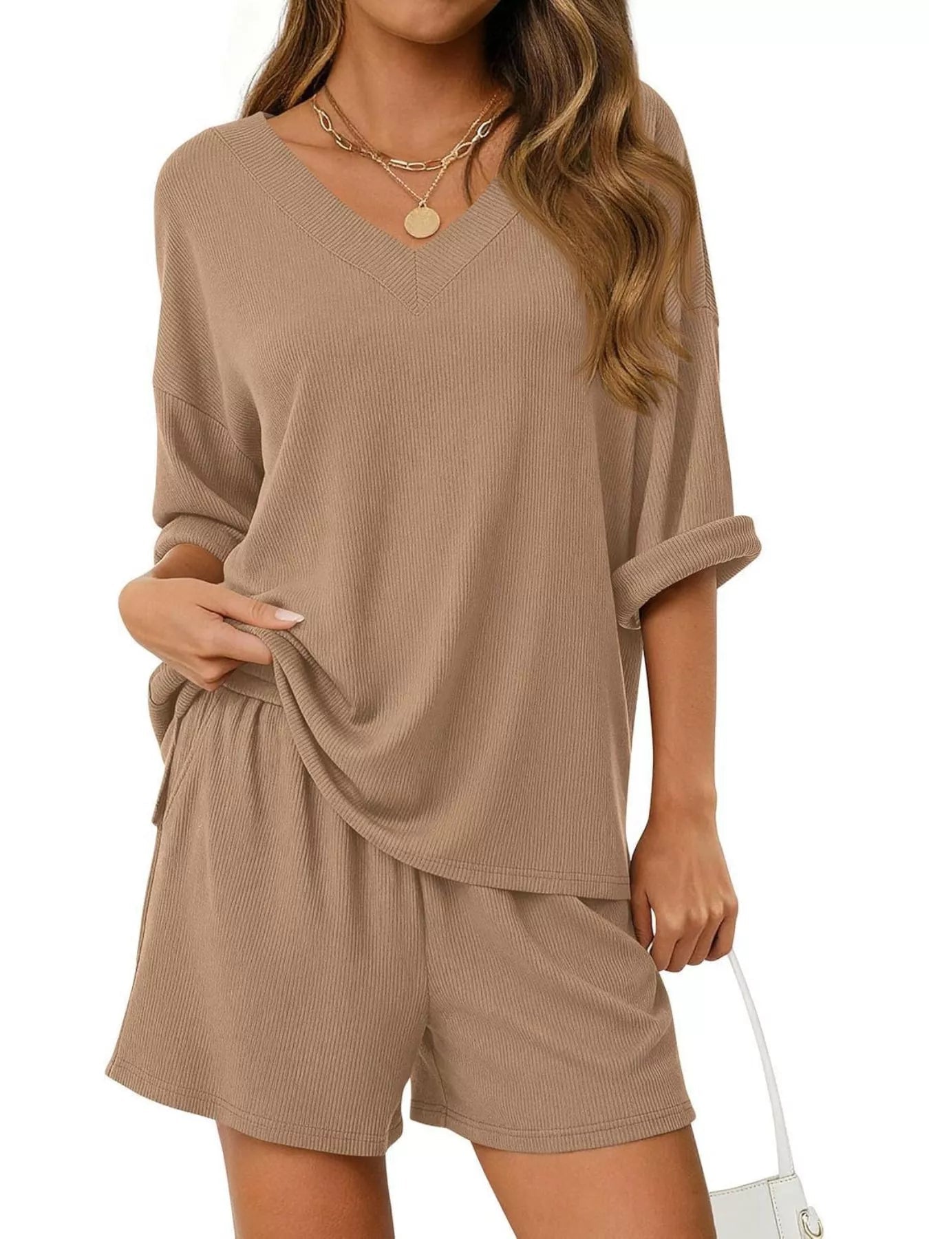 Women's casual V-neck top and shorts set in solid color, trendy two-piece outfits by Trendsi. Perfect for relaxed, stylish wear.