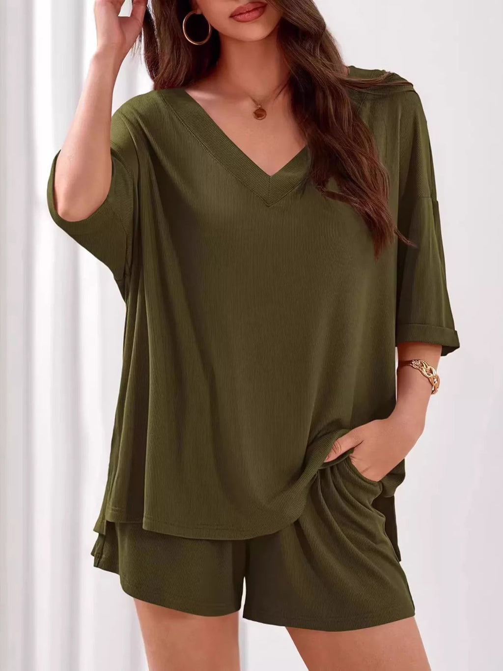 Women's casual V-neck top and shorts set in solid color, trendy two-piece outfit by Trendsi, perfect for relaxed everyday wear.