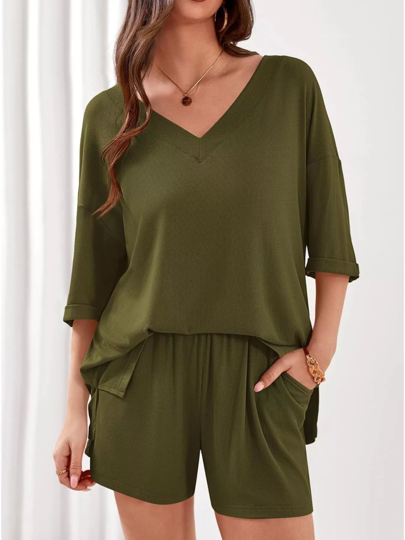 Women's casual V-neck top and shorts set in solid color, trendy two-piece clothing set by Trendsi.