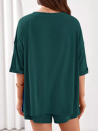 Women's casual V-neck top and shorts set in solid color, trendy two-piece outfit by Trendsi.