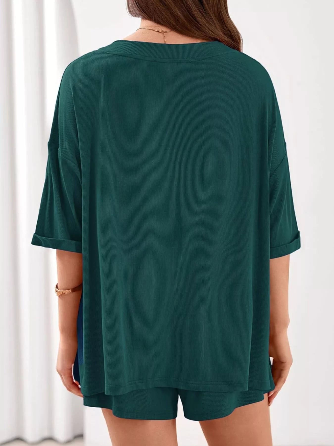 Women's casual V-neck top and shorts set in solid color, trendy two-piece outfit by Trendsi.