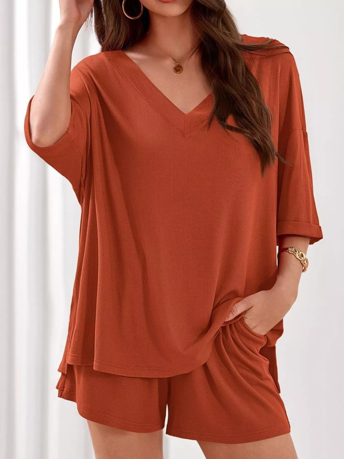 Women's casual V-neck top and shorts set by Trendsi, solid color two-piece outfit, perfect for relaxed everyday wear.