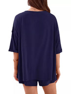 Women's casual V-neck top and shorts set by Trendsi, solid color two-piece outfit, perfect for relaxed everyday wear.