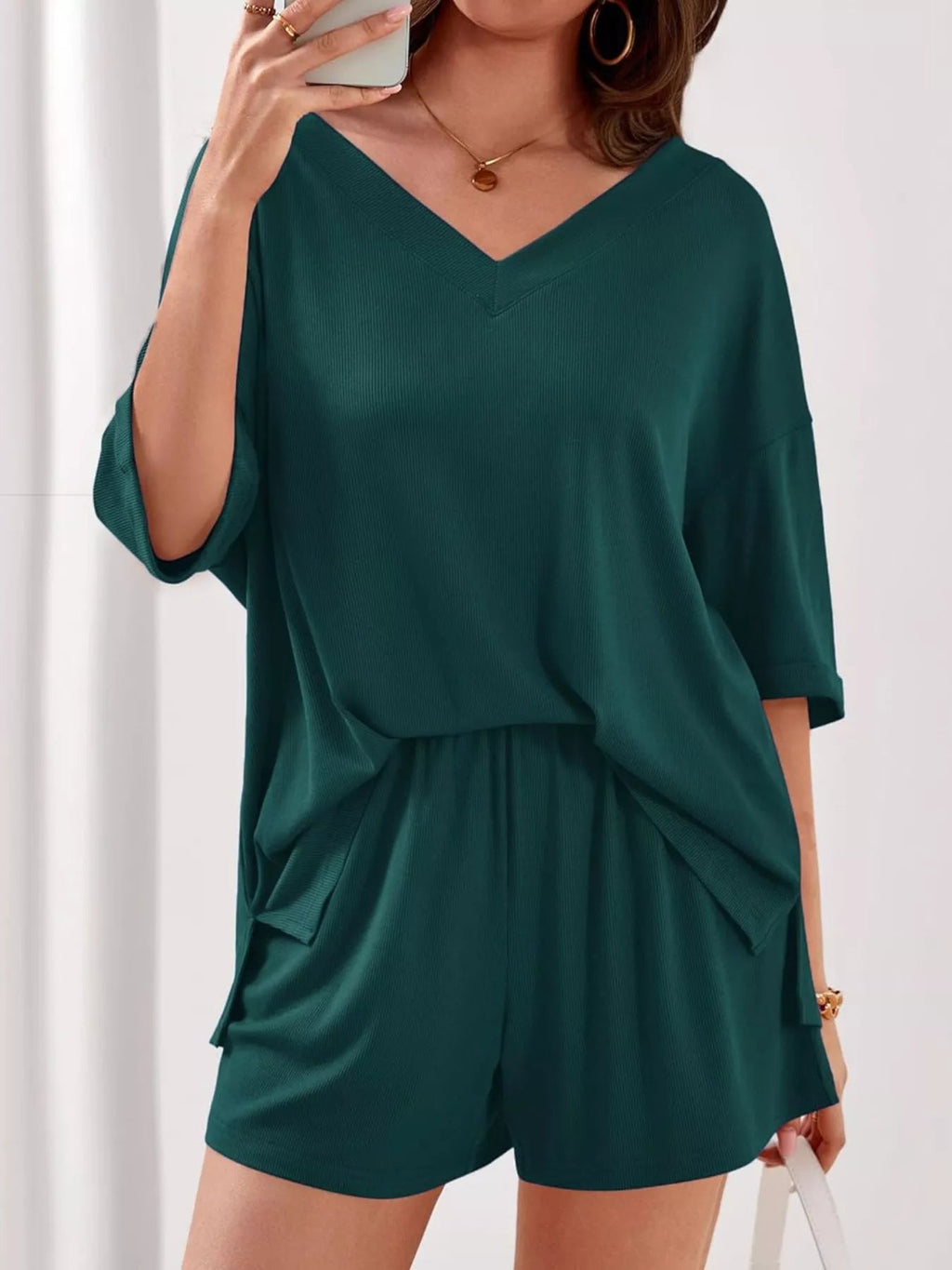 Women's casual V-neck top and shorts set in solid color, trendy two-piece outfit by Trendsi, perfect for everyday wear.