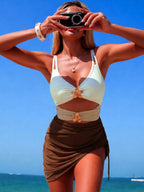 Women's color block cutout one-piece swimsuit by Trendsi, stylish beachwear with vibrant color blocking and cutout details.